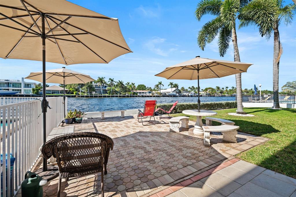 701 South Riverside Drive, Unit 107 Pompano Beach, FL 33062 - Photo 27 of 27 a view of a table and chairs under an umbrella