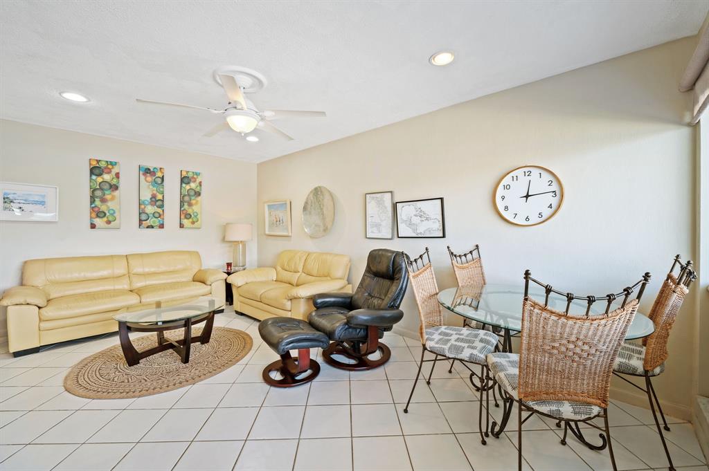 701 South Riverside Drive, Unit 107 Pompano Beach, FL 33062 - Photo 6 of 27 a living room with furniture a clock and a table