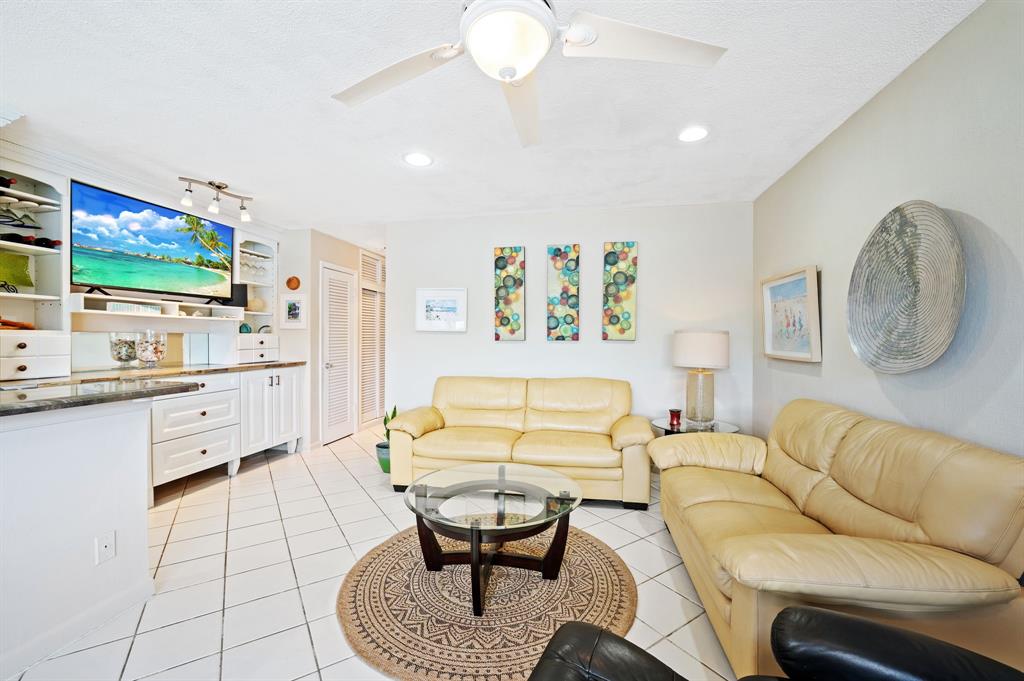 701 South Riverside Drive, Unit 107 Pompano Beach, FL 33062 - Photo 7 of 27 a living room with furniture and a large window