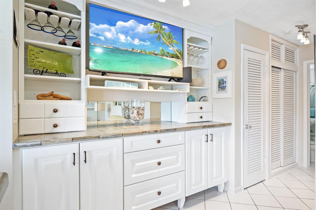 701 South Riverside Drive, Unit 107 Pompano Beach, FL 33062 - Photo 8 of 27 a kitchen with white cabinets a sink and a window