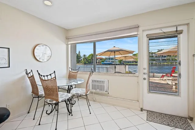 a dining room with furniture and a large window
