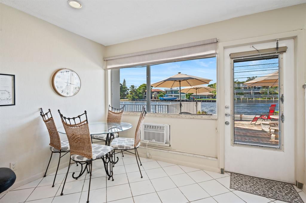 701 South Riverside Drive, Unit 107 Pompano Beach, FL 33062 - Photo 10 of 27 a dining room with furniture and a large window