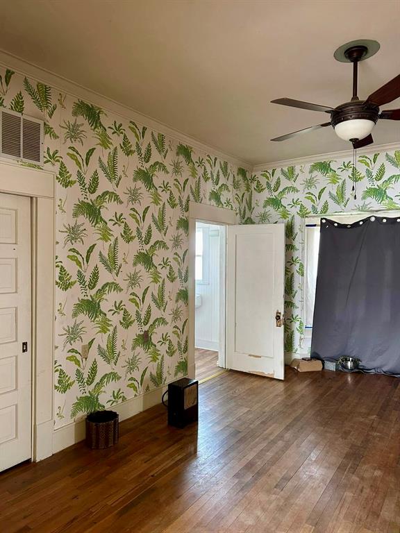 600 Mercer Street Quanah, TX 79252 - Photo 9 of 28 wooden floor in an empty room
