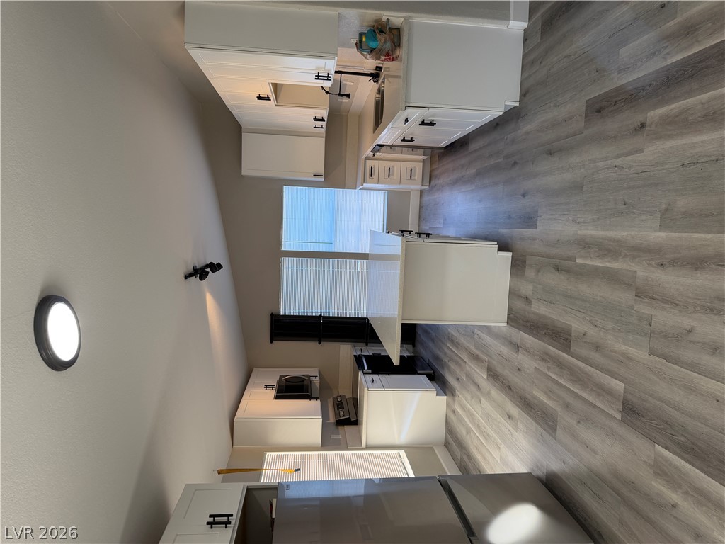 6041 Hafen Ranch Road Pahrump, NV 89061 - Photo 5 of 12 A contemporary kitchen showcasing sleek appliances and durable wood flooring.