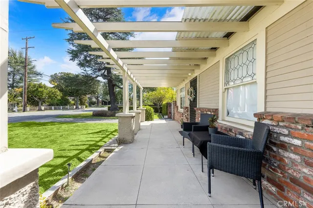 a living room with patio furniture and garden