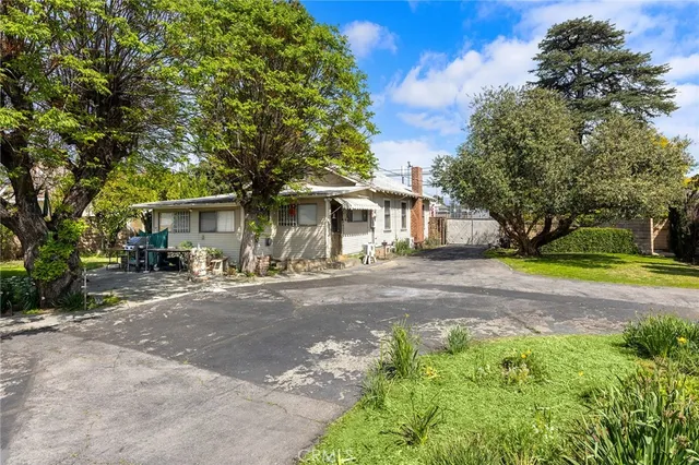 a front view of a house with yard and green space
