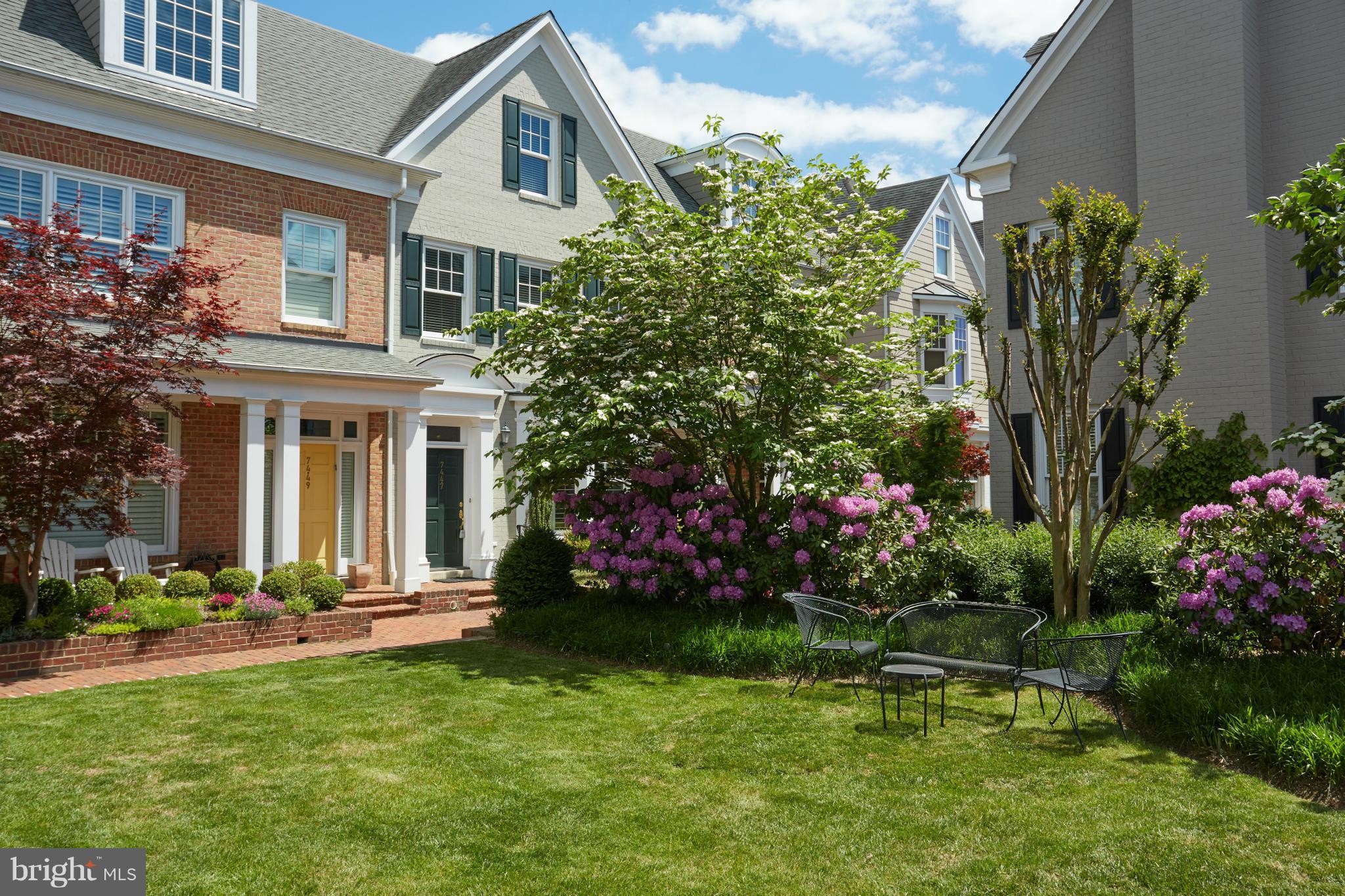 7447 Arlington Road Bethesda, MD 20814 - Photo 2 of 20 a front view of a house with a yard and fountain in middle