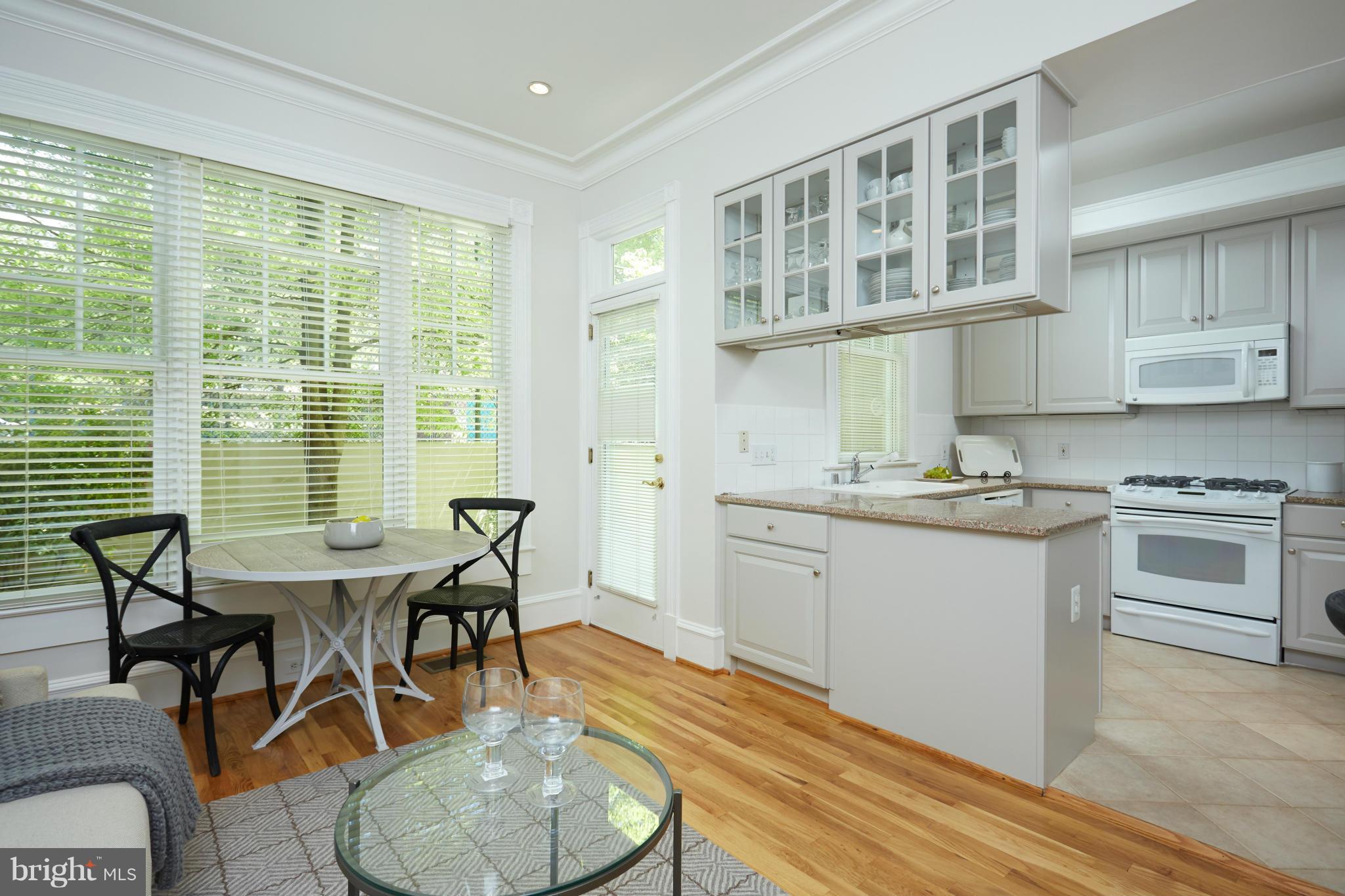7447 Arlington Road Bethesda, MD 20814 - Photo 11 of 20 a view of a dining room with furniture window and wooden floor