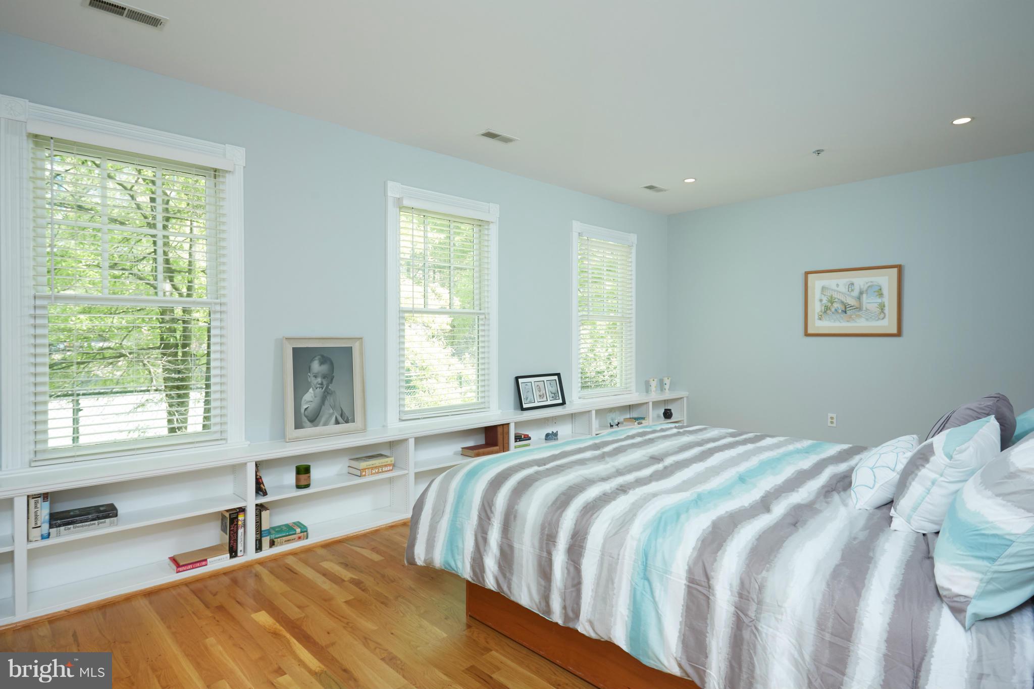 7447 Arlington Road Bethesda, MD 20814 - Photo 12 of 20 a bedroom with a bed and a large window