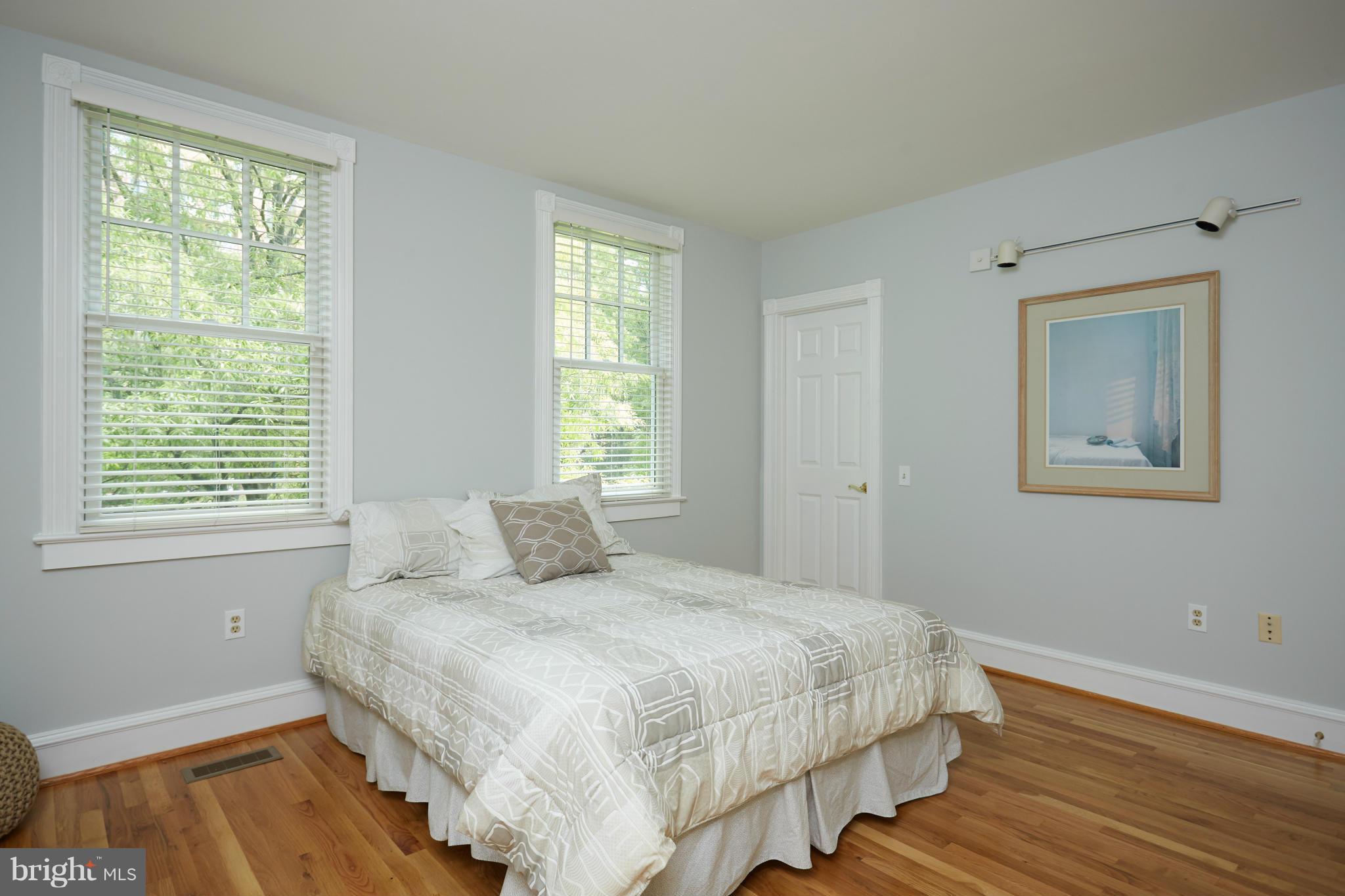 7447 Arlington Road Bethesda, MD 20814 - Photo 16 of 20 a bedroom with a bed and wooden floor