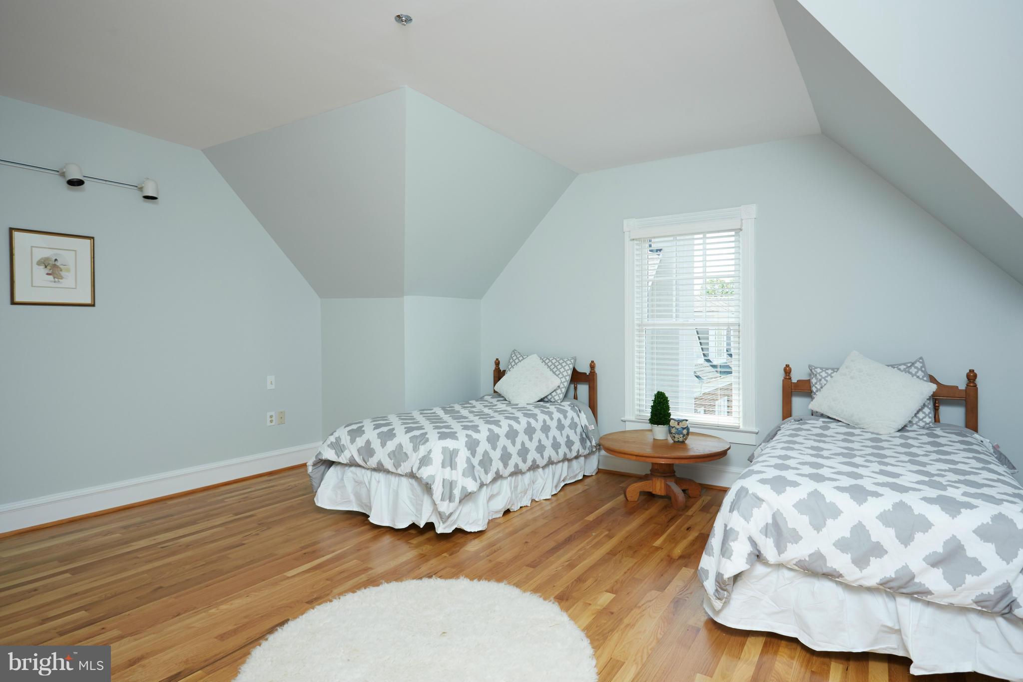 7447 Arlington Road Bethesda, MD 20814 - Photo 18 of 20 a bedroom with two beds and painting on the wall