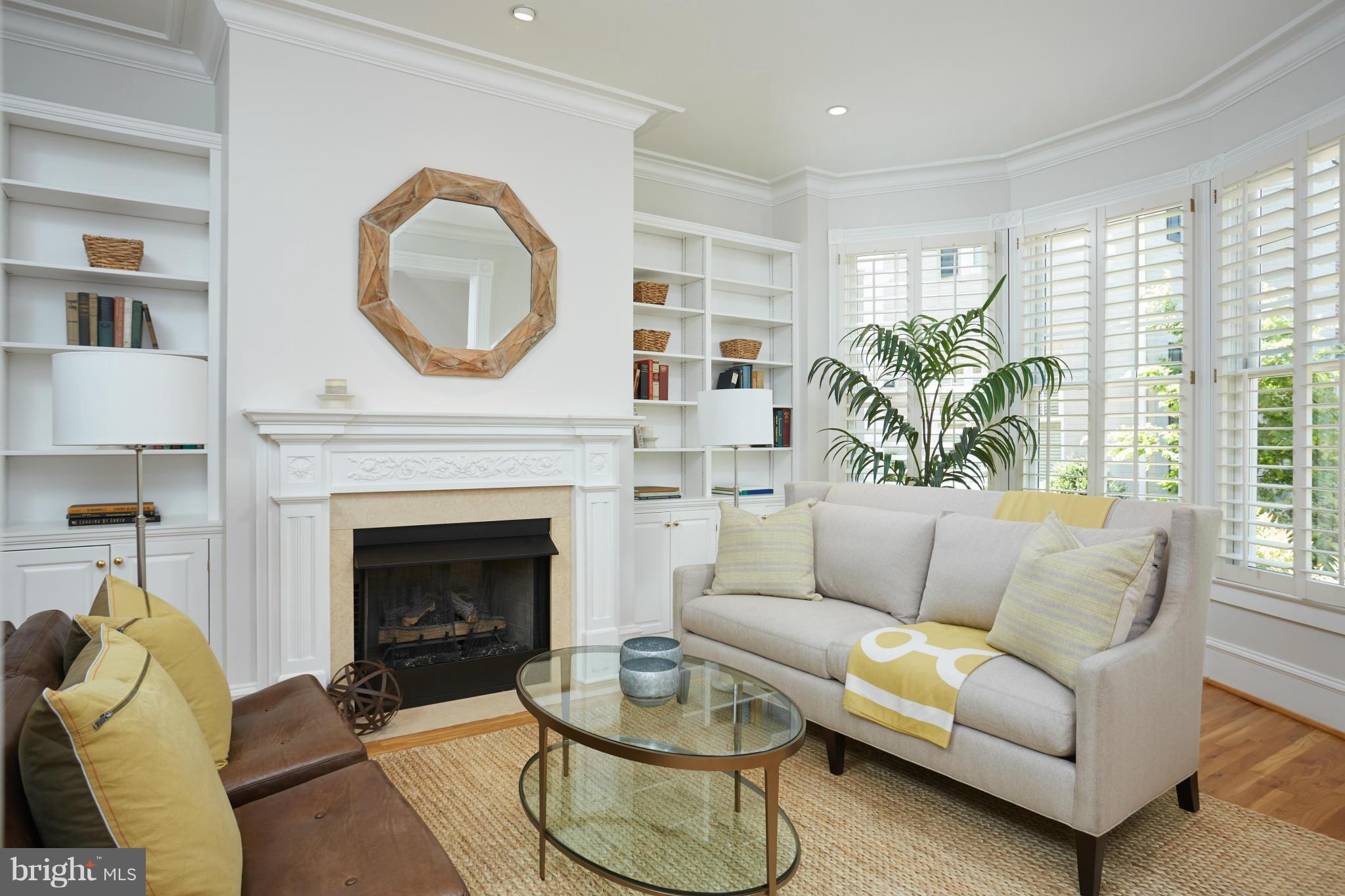 7447 Arlington Road Bethesda, MD 20814 - Photo 3 of 20 a living room with furniture a fireplace and a large window