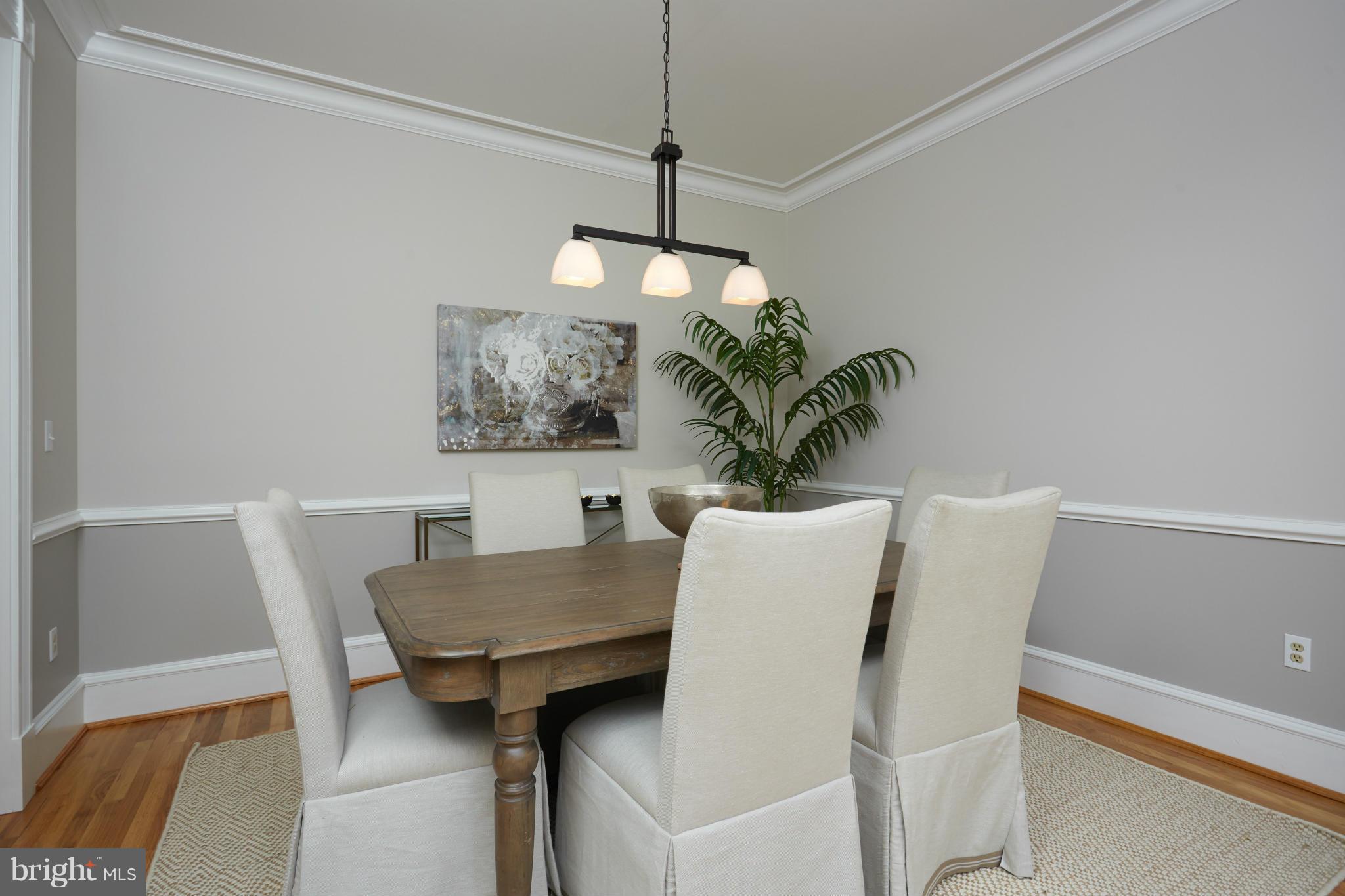 7447 Arlington Road Bethesda, MD 20814 - Photo 7 of 20 a view of a dining room with furniture and wooden floor