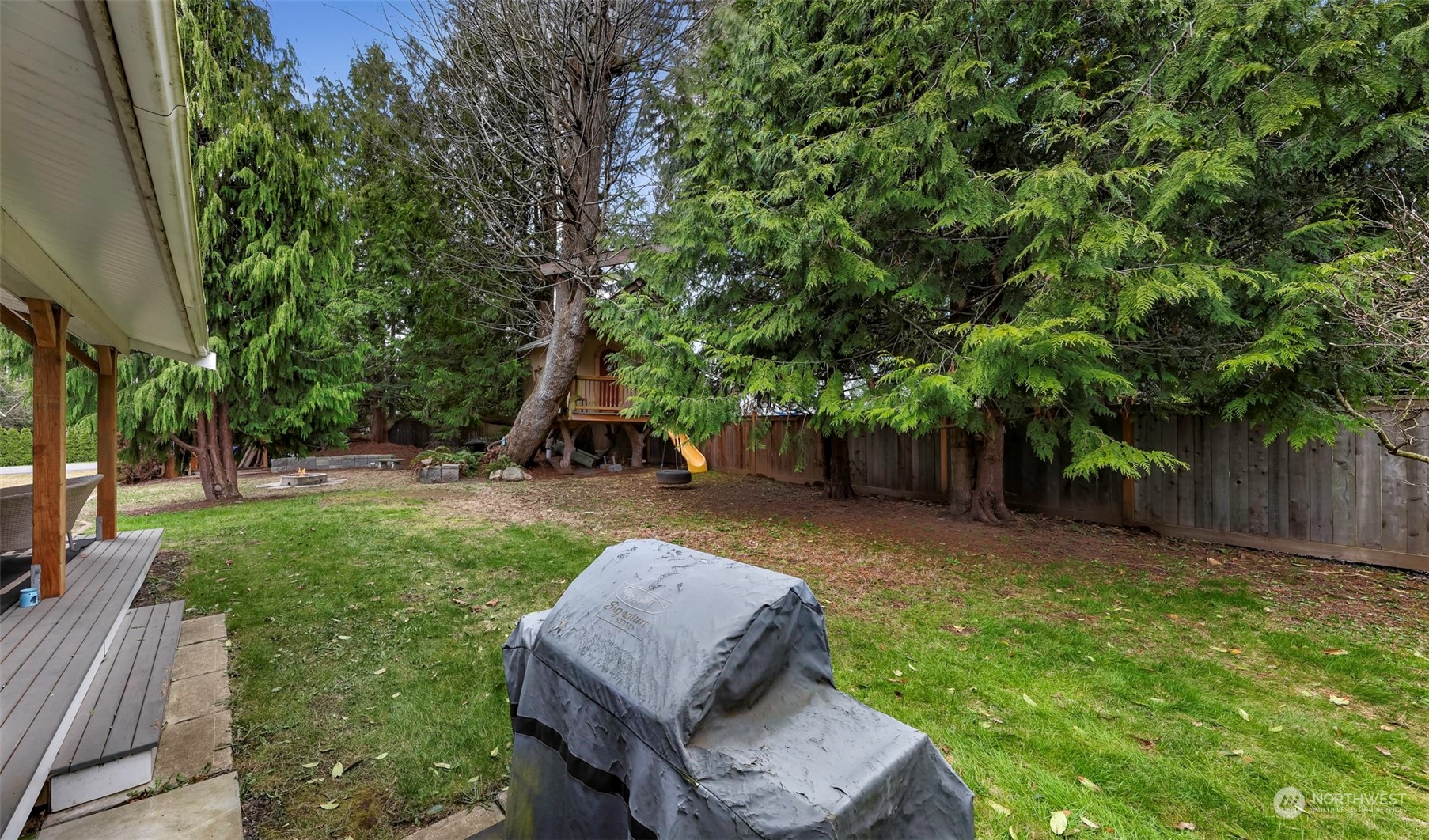 4532 Decatur Drive Ferndale, WA 98248 - Photo 27 of 32 a view of a backyard with couches plants and large trees