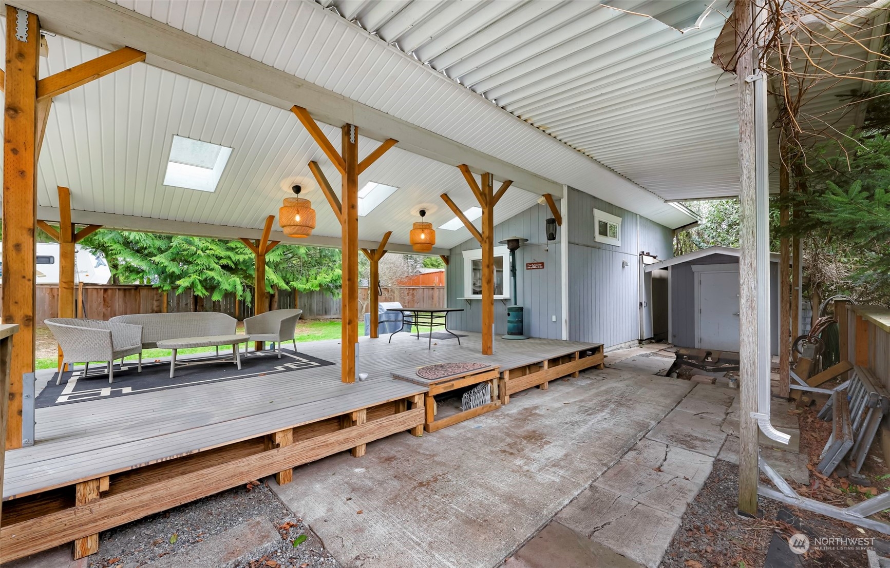 4532 Decatur Drive Ferndale, WA 98248 - Photo 4 of 32 a backyard of a house with barbeque oven table and chairs
