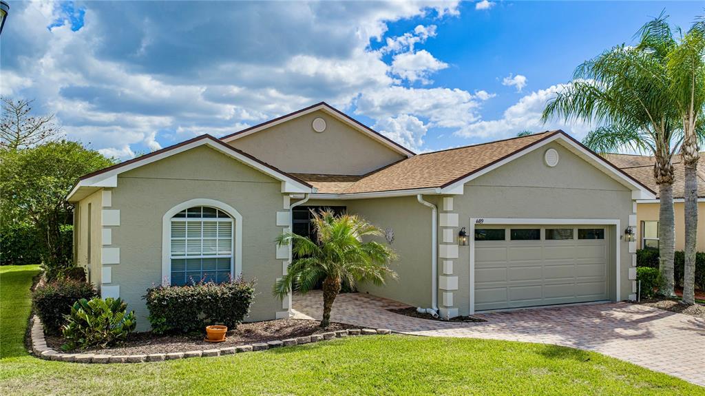 4489 Strathmore Drive Lake Wales, FL 33859 - Photo 1 of 89 a front view of a house with a yard and potted plants