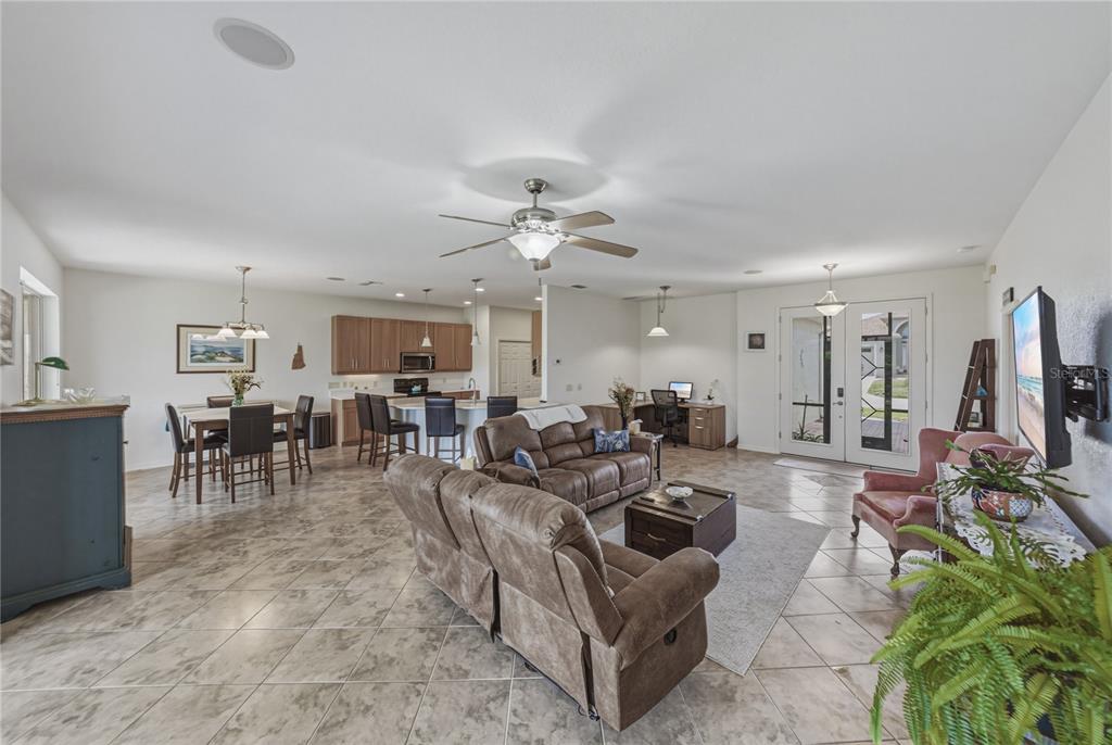 4489 Strathmore Drive Lake Wales, FL 33859 - Photo 12 of 89 a living room with furniture a flat screen tv and a large window