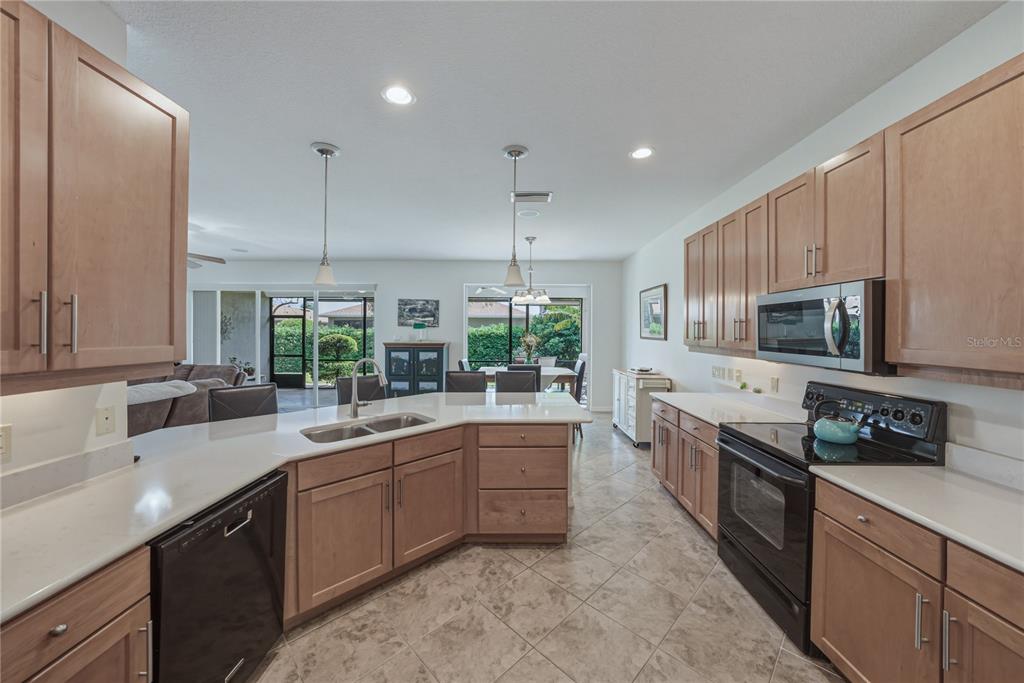 4489 Strathmore Drive Lake Wales, FL 33859 - Photo 21 of 89 a kitchen with stainless steel appliances kitchen island granite countertop a sink a stove and cabinets