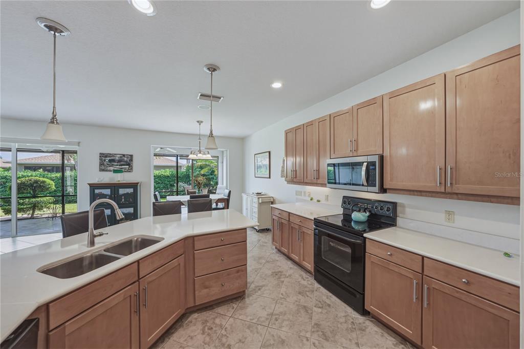 4489 Strathmore Drive Lake Wales, FL 33859 - Photo 22 of 89 a kitchen with kitchen island granite countertop a sink a counter space appliances and cabinets