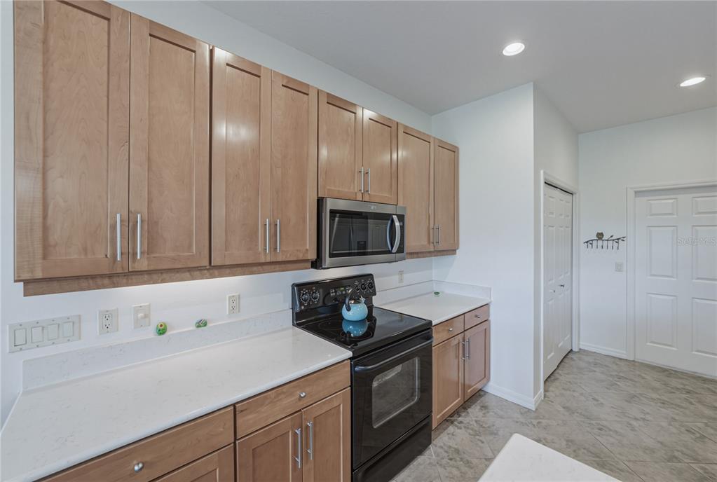 4489 Strathmore Drive Lake Wales, FL 33859 - Photo 23 of 89 a kitchen with a sink cabinets and stainless steel appliances