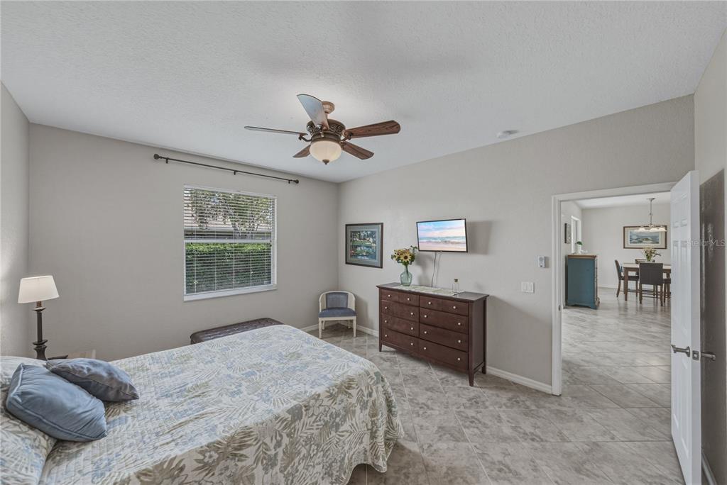 4489 Strathmore Drive Lake Wales, FL 33859 - Photo 26 of 89 a bedroom with a bed and a chandelier