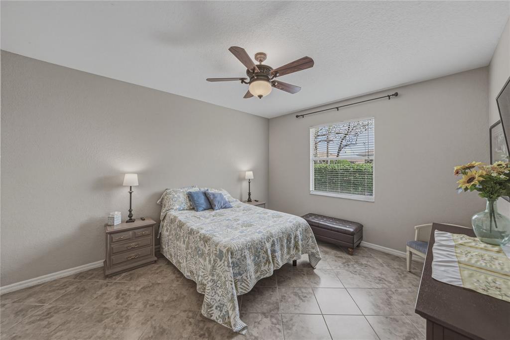 4489 Strathmore Drive Lake Wales, FL 33859 - Photo 27 of 89 a bedroom with a bed and a table in it