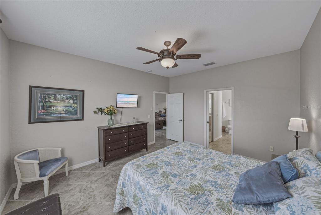 4489 Strathmore Drive Lake Wales, FL 33859 - Photo 29 of 89 a bedroom with a bed and a dresser in it