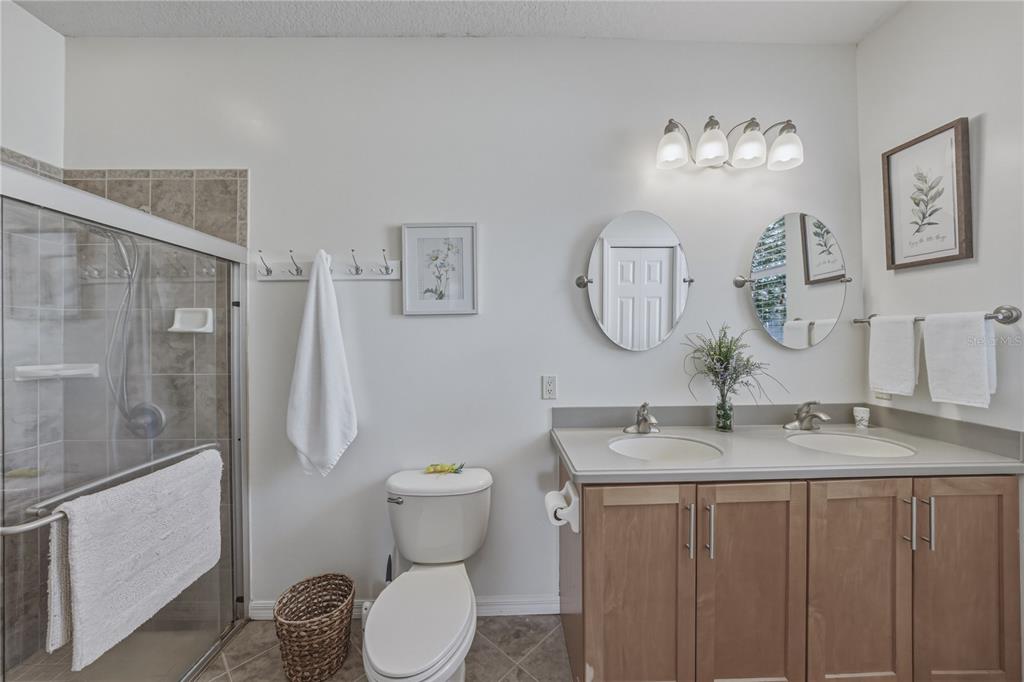 4489 Strathmore Drive Lake Wales, FL 33859 - Photo 31 of 89 a bathroom with a granite countertop sink toilet and shower