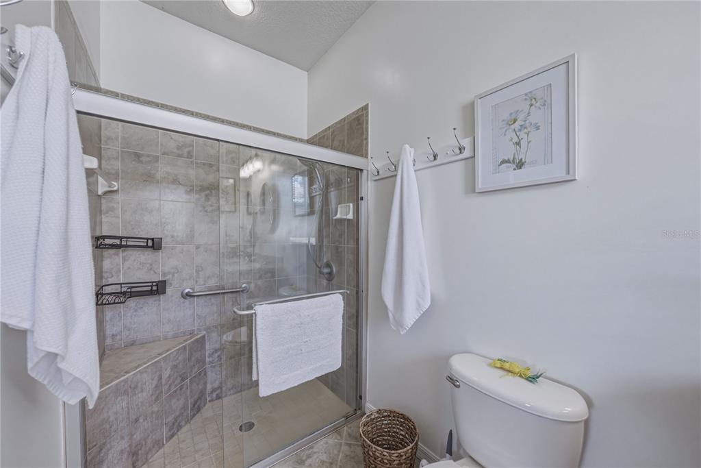 4489 Strathmore Drive Lake Wales, FL 33859 - Photo 32 of 89 a bathroom with a shower and toilet