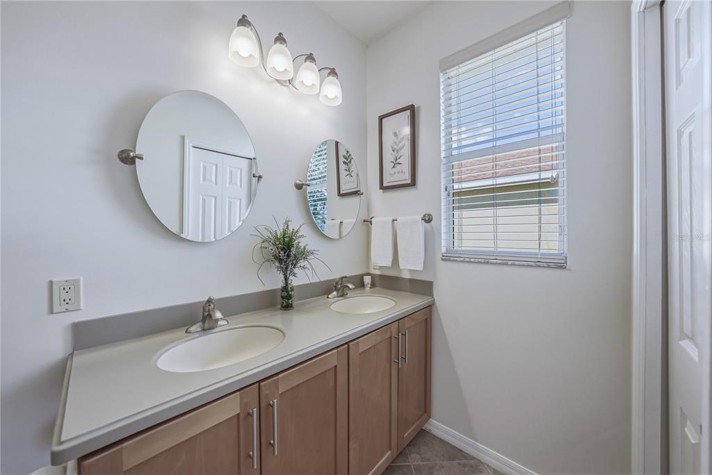 4489 Strathmore Drive Lake Wales, FL 33859 - Photo 33 of 89 a bathroom with a sink and a mirror