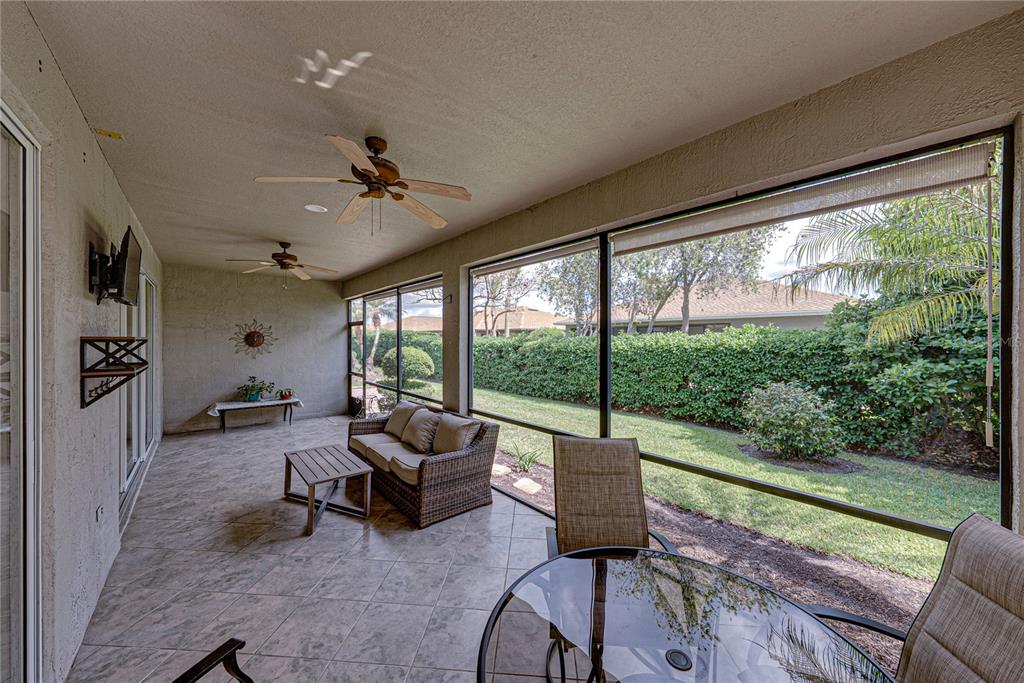 4489 Strathmore Drive Lake Wales, FL 33859 - Photo 47 of 89 a living room with furniture tv and a floor to ceiling window