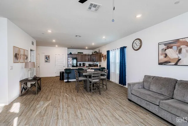 a view of a workspace with furniture and wooden floor