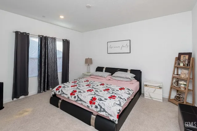 a bedroom with a bed and a dresser in it