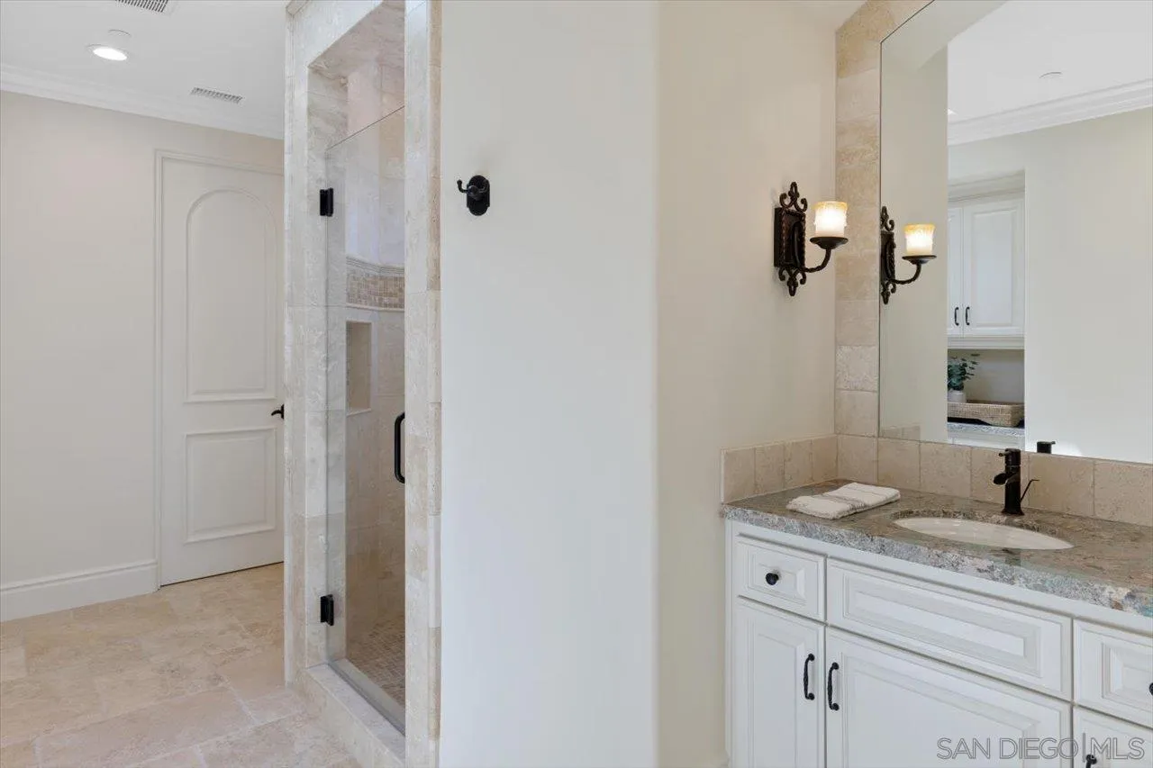 1015 Gardena Road Encinitas, CA 92024 - Photo 30 of 45 a bathroom with a granite countertop sink a mirror and shower