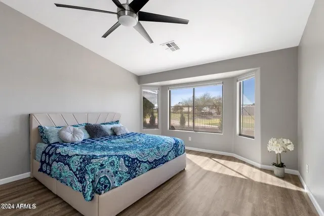 a bedroom with a large bed and a window