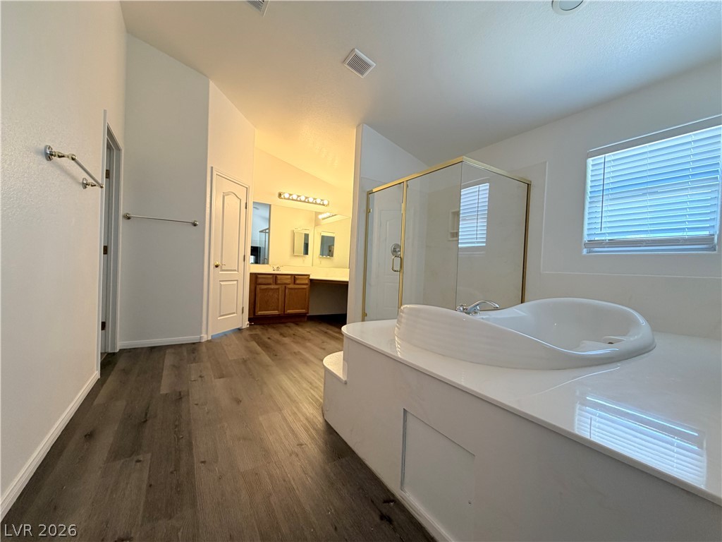 6116 Rabbit Track Street Las Vegas, NV 89130 - Photo 14 of 28 Indulge in a tranquil primary bathroom featuring a spacious soaking tub and a walk-in shower.