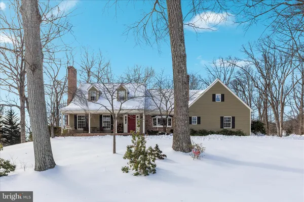 a view of a house with a yard covered in snow
