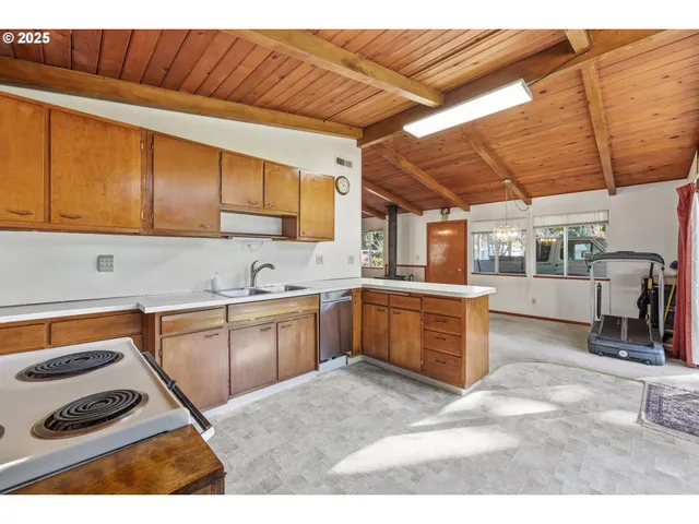 a kitchen with a sink cabinets and window