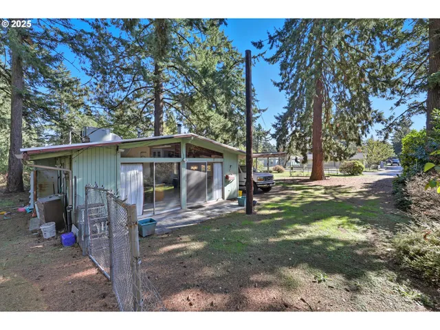 a backyard of a house with a table and chairs