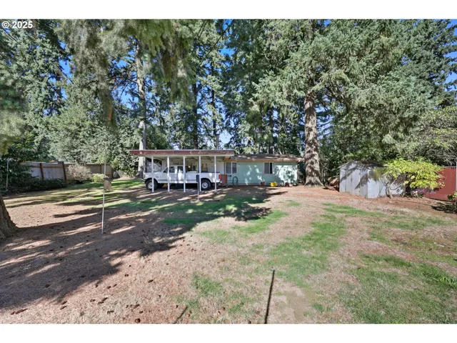 a view of yard with swimming pool and trees