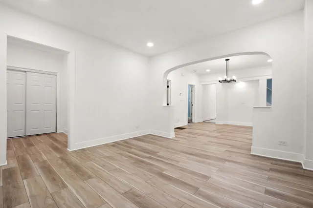 a view of empty room with wooden floor
