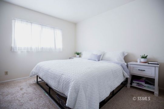 122 South Valley Street Ridgecrest, CA 93555 - Photo 13 of 26 a large bed sitting in a bedroom next to a window