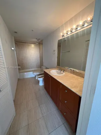 a bathroom with a sink toilet and mirror