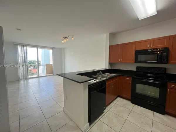 a kitchen with granite countertop a stove and a sink