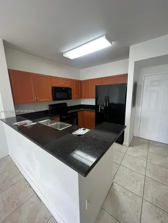 a kitchen with a sink and a stove top oven