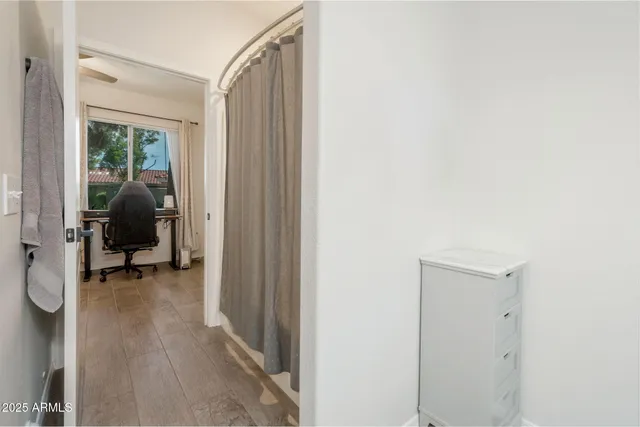 a view of a room with gym equipment and a mirror