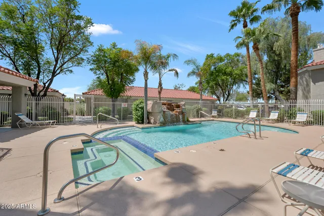 a swimming pool with outdoor seating and yard