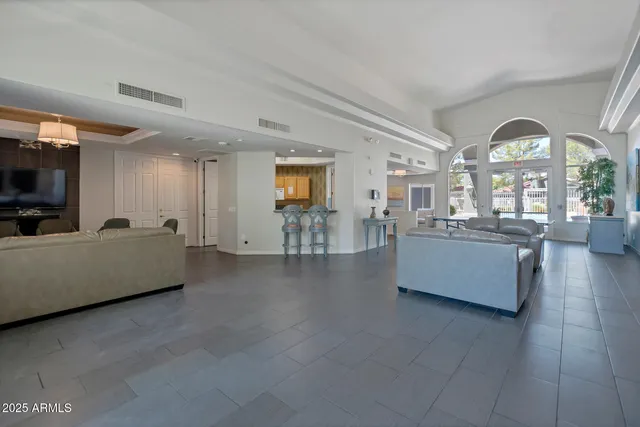 a view of a living room and kitchen with furniture