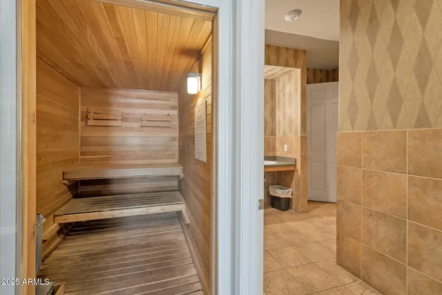 a bathroom with a walk in closet and wooden floor