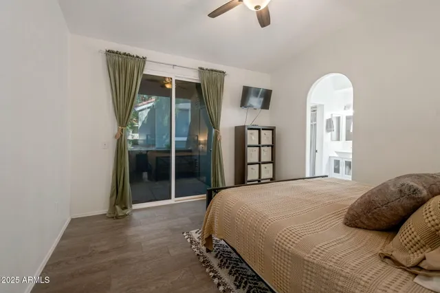 a bedroom with a large bed and a chandelier